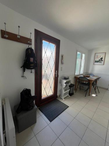 une chambre avec une porte, une table et une table dans l'établissement Départ du marin, à Saint-Pierre-dʼOléron