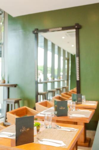a dining room with wooden tables and chairs at Accra Luxury Apartments @ The Lennox in Accra