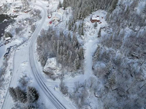 an aerial view of a road with snow and trees at Maxi Cabin with Sauna and Jacuzzi in Kovan