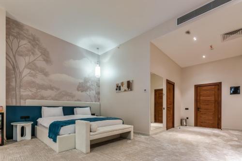 a bedroom with a large bed with a blue blanket at Monte Napoleone Hotel in Baku