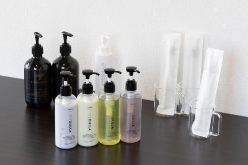 a group of four bottles sitting on a table at SLEEPLAB THE STAY Casual 西新宿 in Tokyo