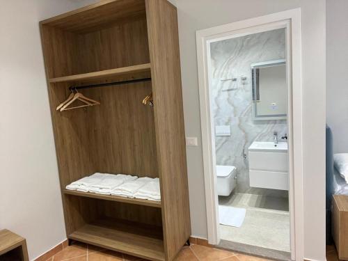 a bathroom with a shower with a toilet and a sink at Vila ENSO in Berat