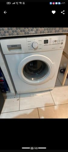 a white washing machine sitting on top of a counter at Haval in Idar-Oberstein