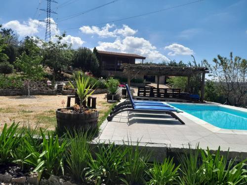 a pool with a gazebo and a house at Bungalow da Pedreira in Viseu