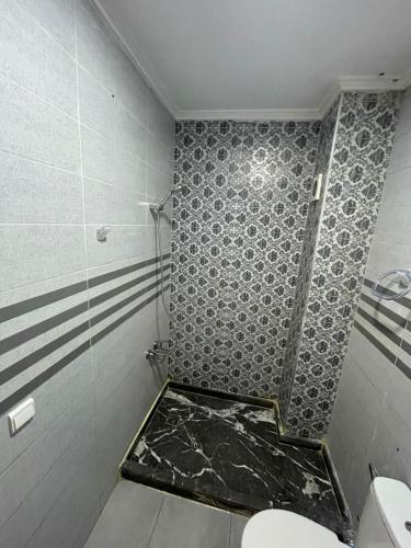a bathroom with a shower and a toilet in it at Appartement royal à tanger in Tangier