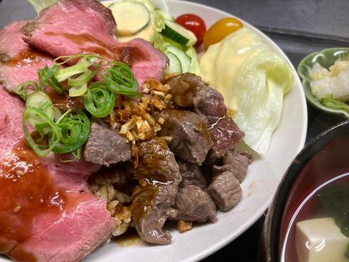 a plate of food with meat and other foods at Flower Garden in Takamori