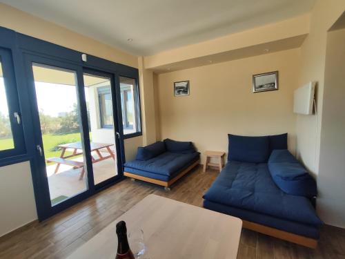 a living room with blue couches and a table at BlueTel Lixouri in Lixouri