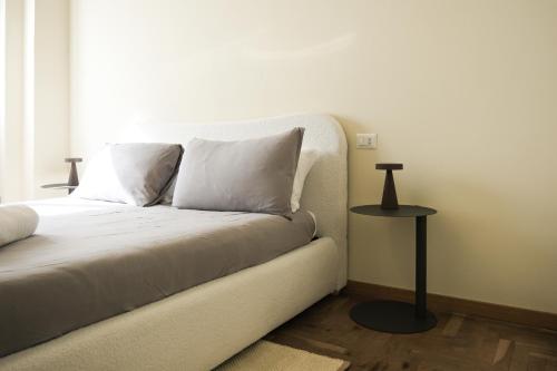 a white couch with two pillows and a table at La Maison 2 min walk to Bernina Express in Tirano
