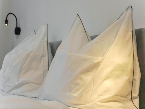 two white pillows sitting on top of a bed at Leni Top 1 in Dienten am Hochkönig
