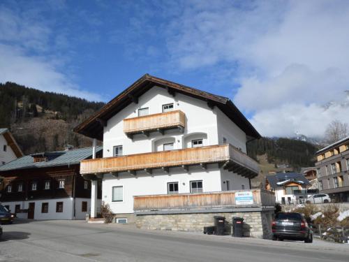 a large white building with a brown roof at Leni Top 1 in Dienten am Hochkönig