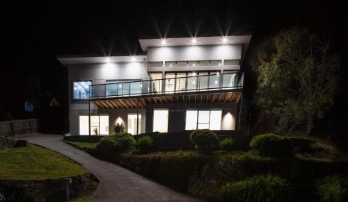 a large house at night with lights on it at The MBM - Modern 4BR Home, Spacious, Views, Ideal for Groups in Montagu Bay