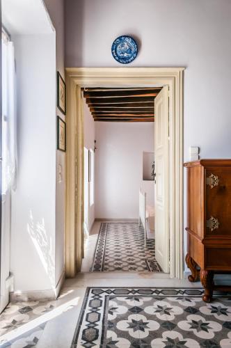 a hallway with a clock on the wall at Nearchos House in Plaka Milou