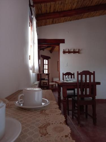 a room with a table and chairs and a dining room at Departamentos Complejo Turístico Cruz Mendoza in Tilcara