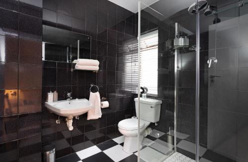 a bathroom with a toilet and a sink at Camps Bay private room and bathroom in Cape Town