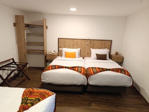 a bedroom with two twin beds in a room at Casona Tobar Hotel in Quito