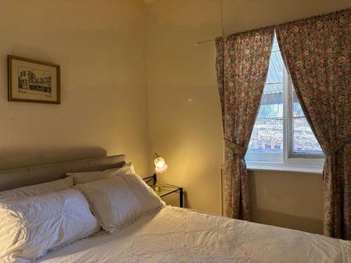 a bedroom with a bed and a window at The Smelters Home Burra in Burra