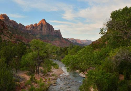 a river in a canyon with mountains in the background at Yurt Overlook #3 with AC and Private Bath 2 Kings in Orderville