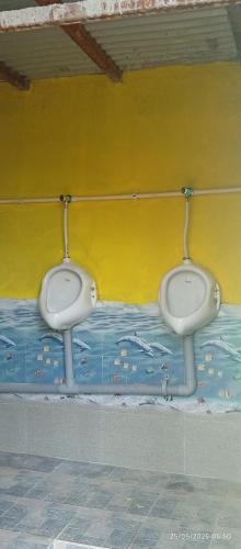 two white urinals on a wall in a room at Everest Home Stay Temal Kalimati Tower in Thapathali