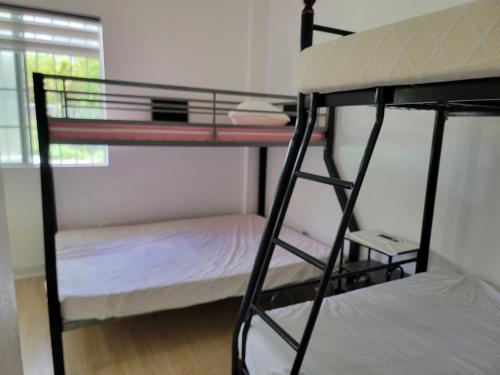 a bedroom with two bunk beds in a room at Green Flash Dive Inn in Garapan
