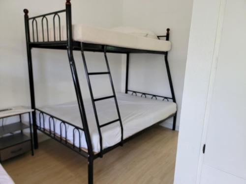 a bedroom with two bunk beds and a ladder at Green Flash Dive Inn in Garapan