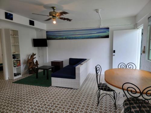 a living room with a couch and a table at Green Flash Dive Inn in Garapan