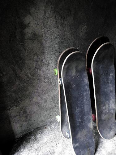 a pair of skateboards sitting against a wall at Merdeka House in Maluk