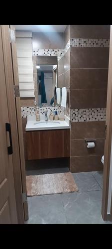 a bathroom with a sink and a mirror at 4K-Suite in Kingston
