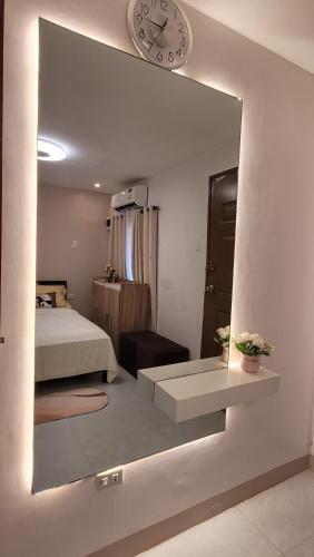 a bedroom with a bed and a large mirror at Vacation Home in Naga City -Jacobes Place in San Felipe