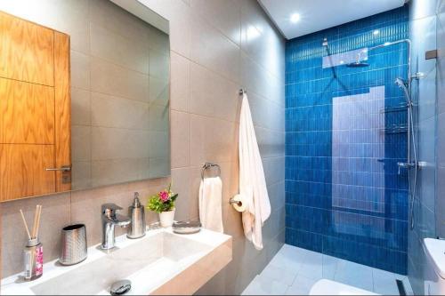 a bathroom with a sink and a glass shower at Villa Marrakech karim in Marrakech