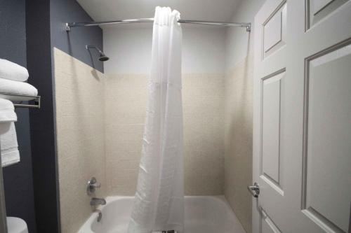 a bathroom with a shower with a white shower curtain at Extended Stay America Suites - Albuquerque - Rio Rancho Blvd in Rio Rancho