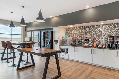 a kitchen with a table and chairs in a room at Extended Stay America Premier Suites - Yuma in Yuma