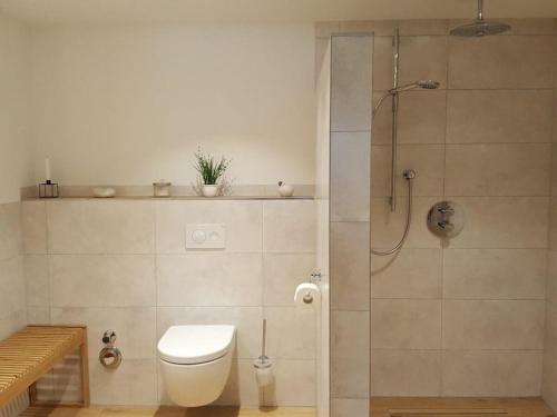 a bathroom with a toilet and a shower at 1-bedroom holiday apartment in Offenburg