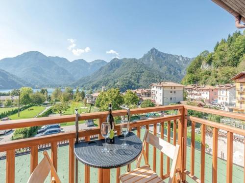 a table on a balcony with a view of mountains at Apartment in Mezzolago with Lake Ledro Views in Mezzolago