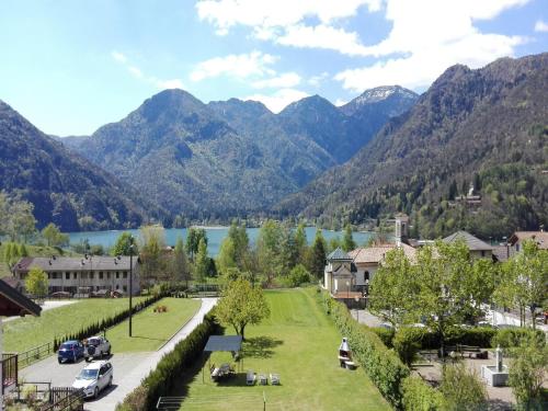 a village with a lake and mountains in the background at Apartment in Mezzolago with Lake Ledro Views in Mezzolago
