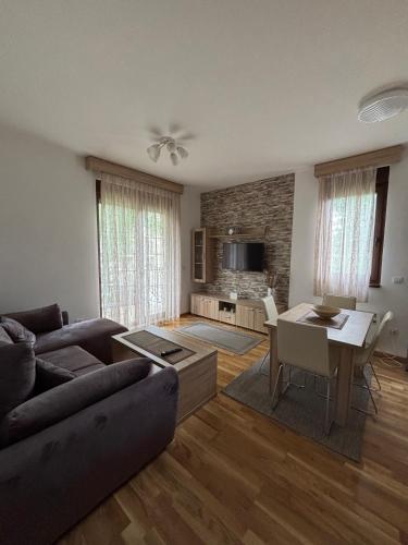 a living room with a couch and a table at Alexandro Apartmani Zlatibor in Zlatibor