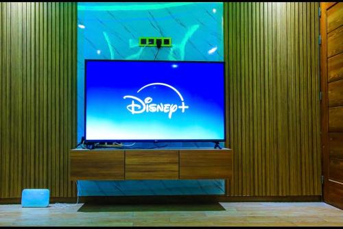 a large screen tv on a wooden wall at Appartement d'luxe agadir Centre in Agadir