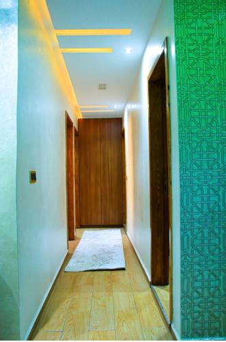 a hallway with a door and a rug on the floor at Appartement d'luxe agadir Centre in Agadir