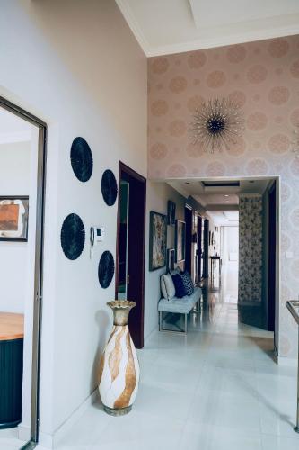 a vase sitting on the floor in a hallway at Escapade Lux Guesthouse in Gaborone