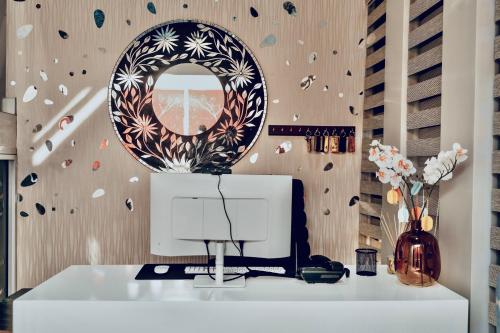 a mirror on top of a white counter in a room at Escapade Lux Guesthouse in Gaborone
