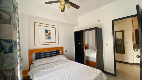 a bedroom with a bed and a ceiling fan at Villa Brune in Baguio