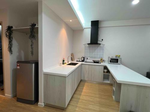 a kitchen with a sink and a counter top at AGROWTH at Aru Suites in Kota Kinabalu