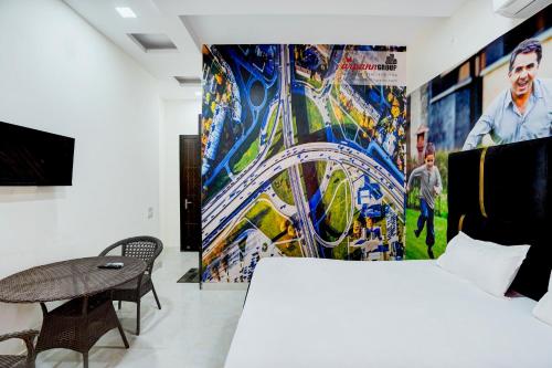 a bedroom with a bed and a painting on the wall at PLAY THE GLORY GR NOIDA couple friendly in Greater Noida