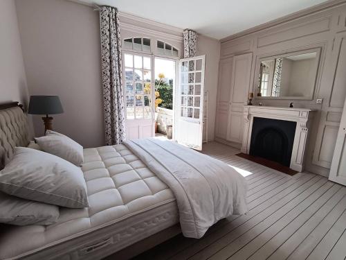 a white bedroom with a bed and a fireplace at Villa spacieuse au Touquet, animaux admis, parking - FR-1-821-36 in Le Touquet-Paris-Plage
