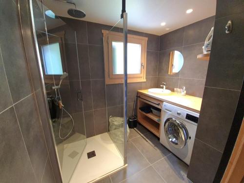 une salle de bain avec douche et machine à laver dans l'établissement Bel appartement T3, centre village, proche pistes, parking - FR-1-459-244, à La Clusaz