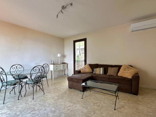 un salon avec un canapé, des chaises et une table dans l'établissement Maison confortable à Banyuls-sur-Mer pour 4 pers. avec terrasse vue mer - FR-1-309-515, à Banyuls-sur-Mer