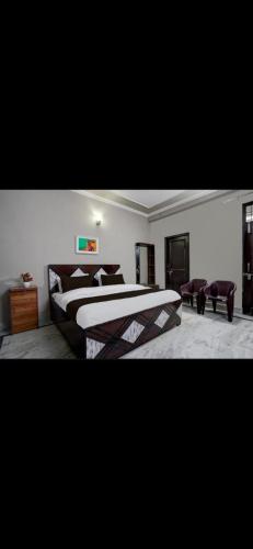 a large bedroom with two beds and a couch at PLAY SHIVANYA RESIDENCY couple friendly in Greater Noida
