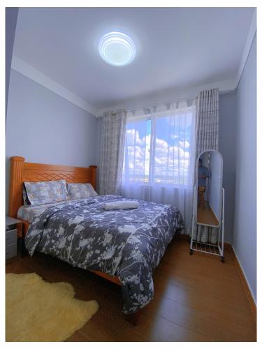 a bedroom with a bed and a window at Alpha homes in Gatunga