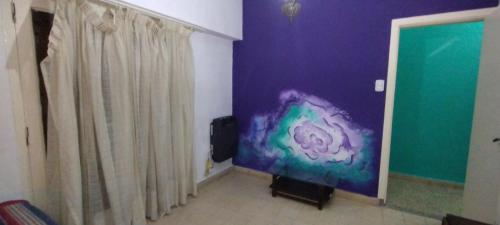 a living room with a large screen tv in a room at Luz Azul Casa de Huéspedes in La Plata