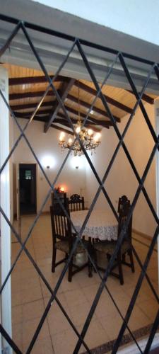 a dining room with a table and a chandelier at Luz Azul Casa de Huéspedes in La Plata