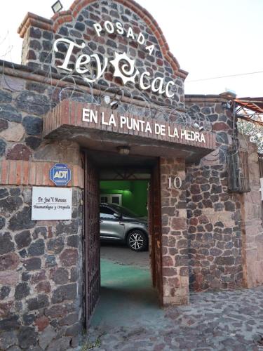 a car parked inside of a building with a garage at Posada Teyecac in San Juan Teotihuacán